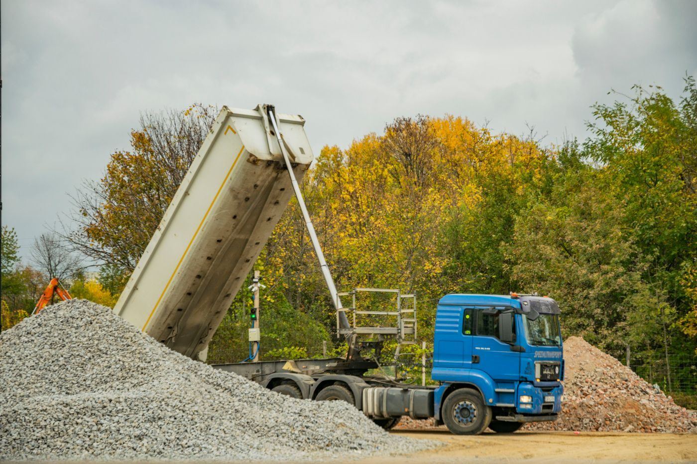 Tipper lorry tipping a load of gravel onto the ground